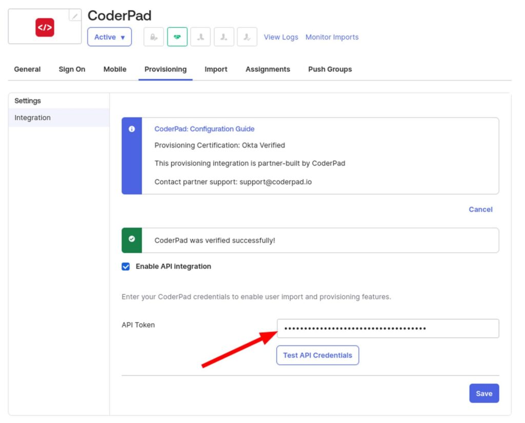 The image shows a screenshot of the CoderPad integration settings page in Okta, specifically under the "Provisioning" tab. The main section includes a blue information box titled "CoderPad: Configuration Guide," indicating the provisioning certification is Okta Verified and that the integration is partner-built by CoderPad, with contact support information provided. Below this, there is a green confirmation message stating "CoderPad was verified successfully!" and a checkbox labeled "Enable API integration," which is checked.

An input field labeled "API Token" is shown with a red arrow pointing to it, and the token is masked with dots. Next to the input field, there is a button labeled "Test API Credentials." At the bottom, there is a "Save" button. The left sidebar menu includes options for Settings and Integration.