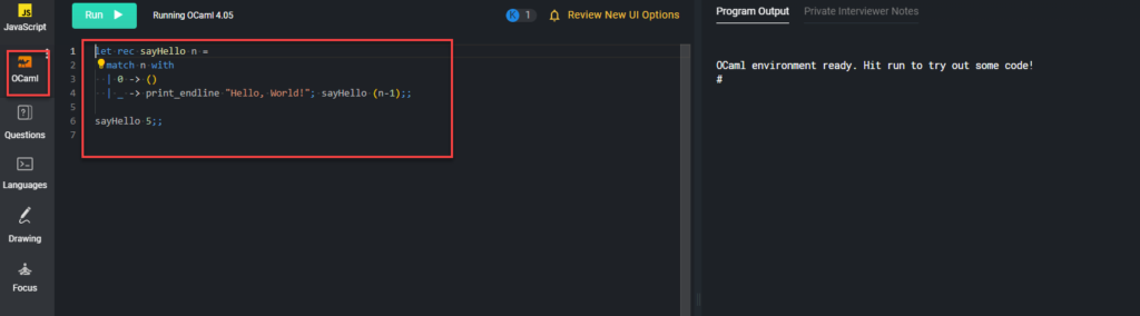 Example "hello world" code is in the left input window and the program output is in the right pad window.